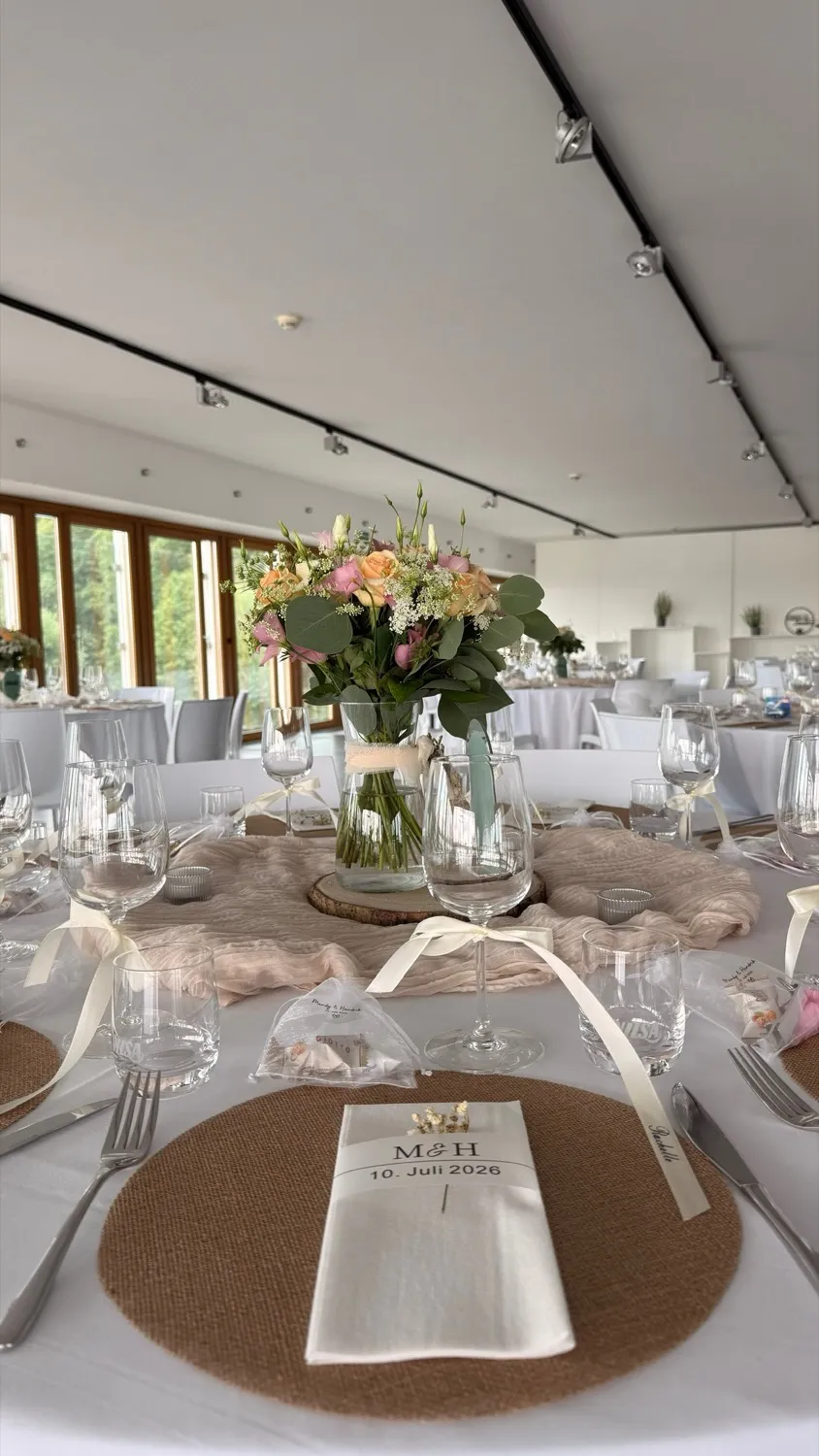 Hochzeitssaal mit Blumenschmuck und Blick ins Grüne